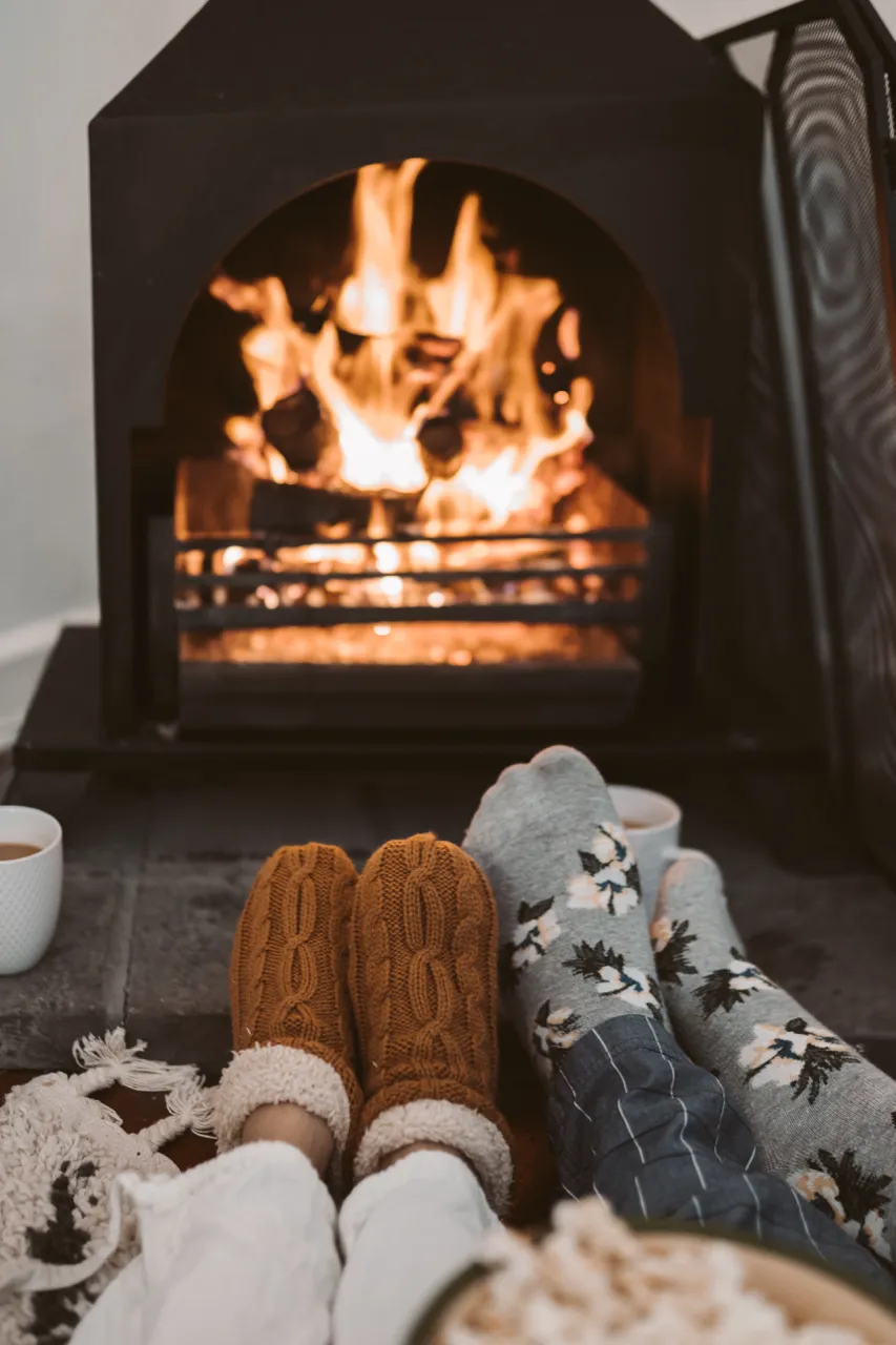 keep home warm in the winter older person slippers socks fire
