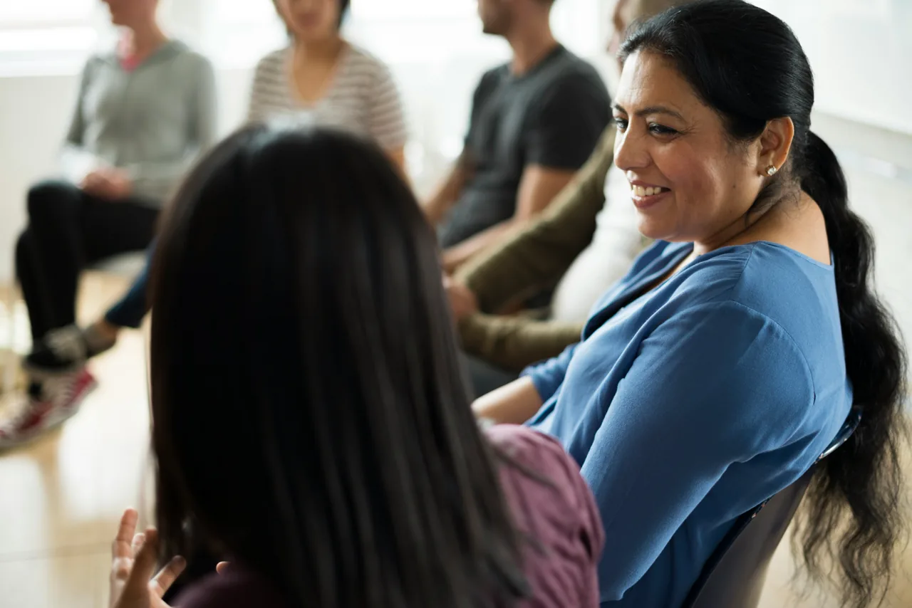 A woman taking part in a group conversation